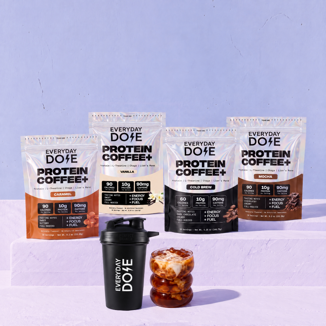 Everyday Dose Protein Coffee+ family in Caramel, Vanilla, Cold Brew and Mocha on a lilac plinth with shaker and iced coffee
