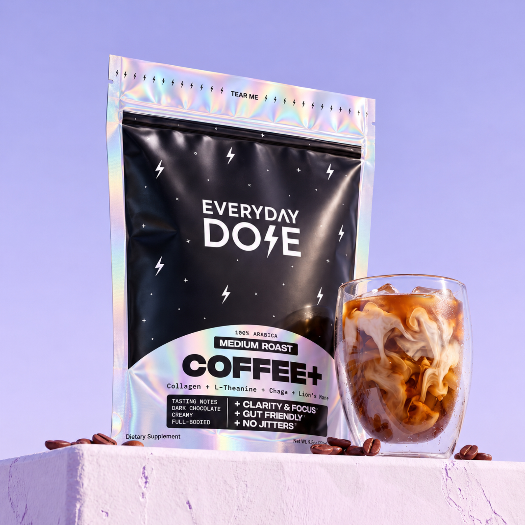 Everyday Dose Coffee+ Medium Roast pouch with iced coffee in a double-wall glass on a lilac plinth
