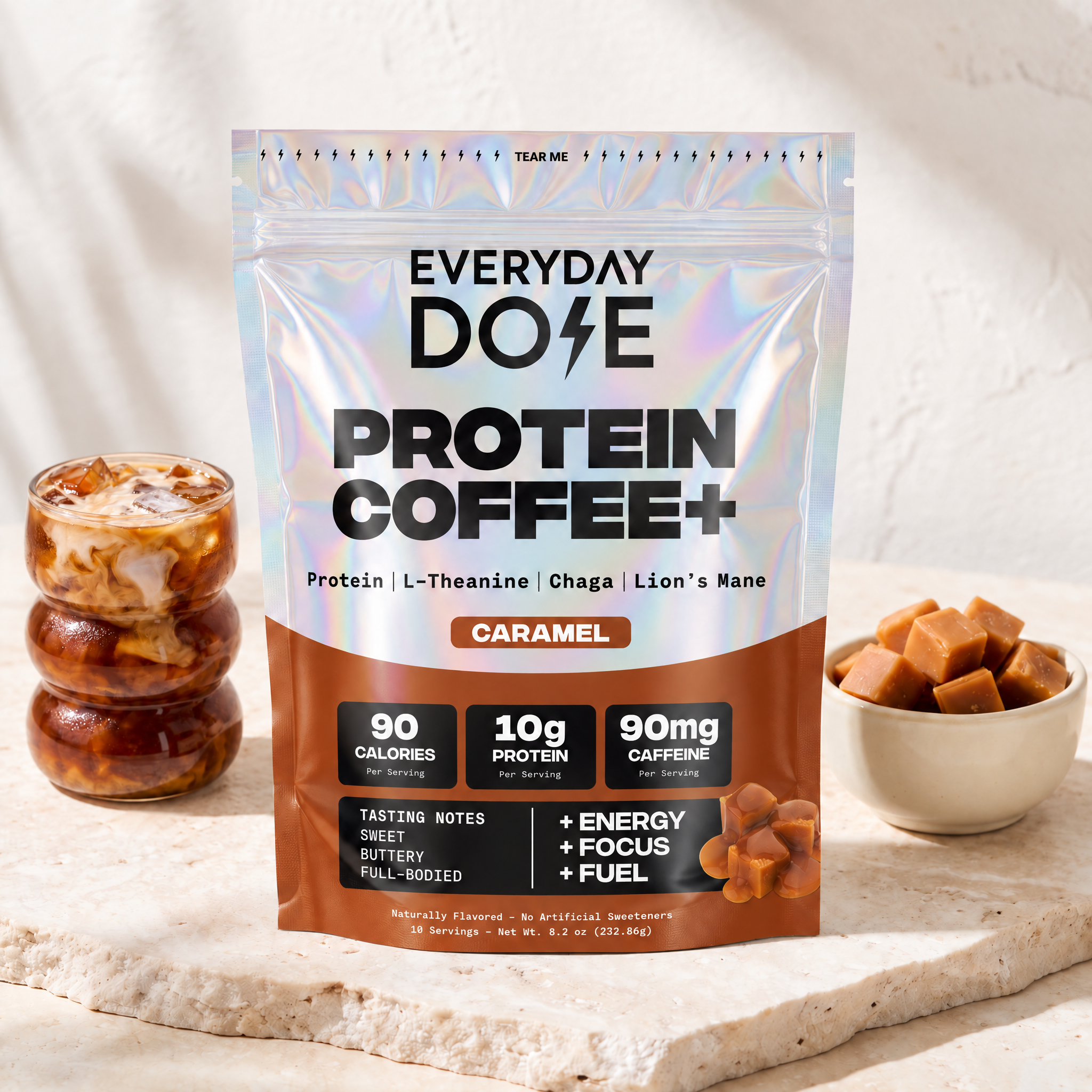 Everyday Dose Protein Coffee+ Caramel with iced coffee and caramel cubes on travertine