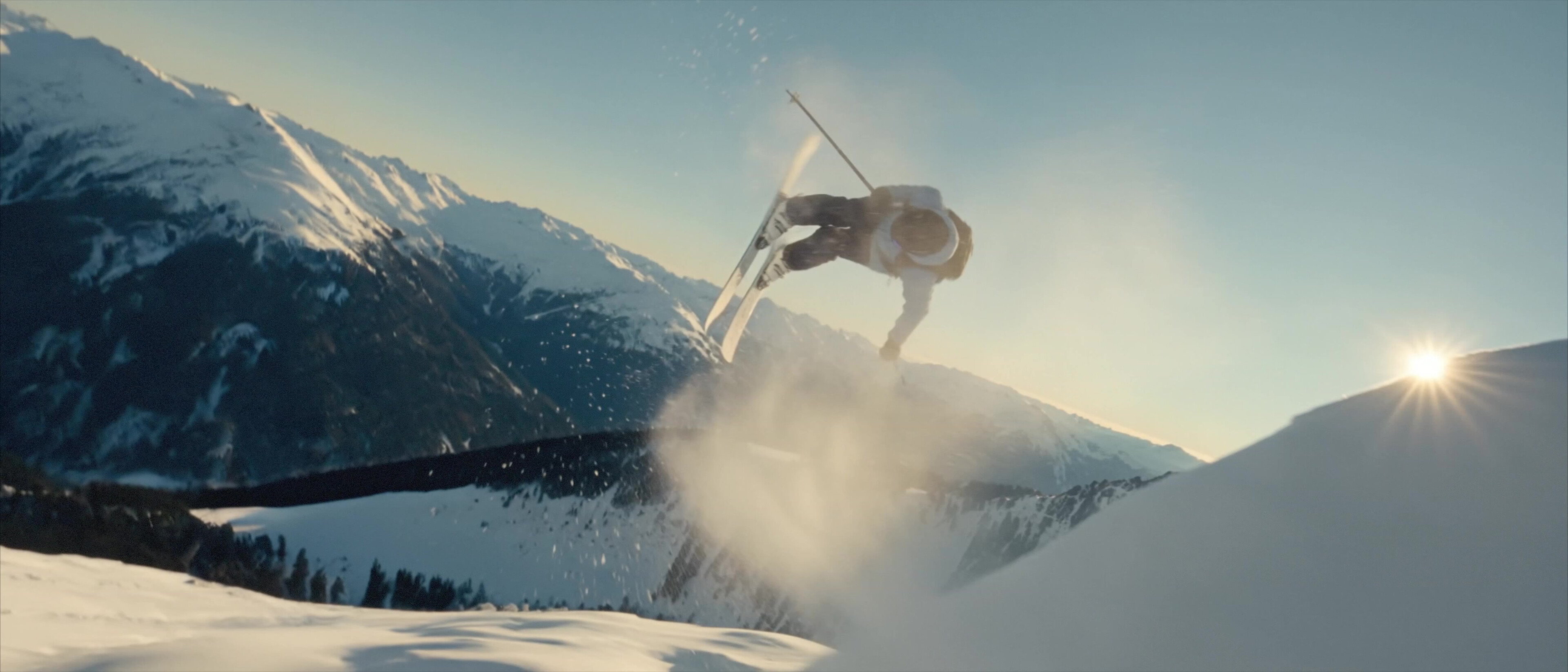 Moccamaster ICE - Skier jumping off a ridge with the sun flaring behind