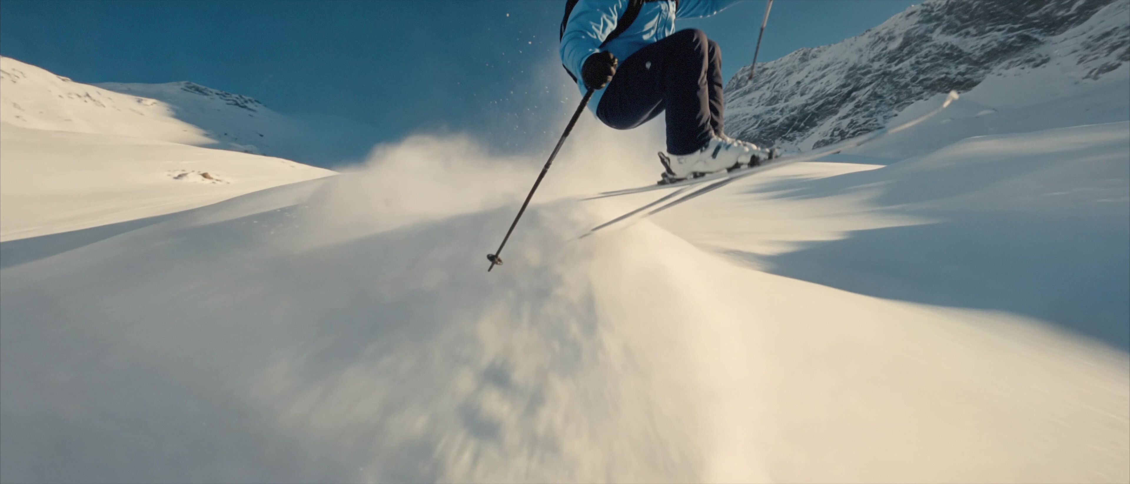 Moccamaster ICE - Low-angle shot of a skier carving through powder spray