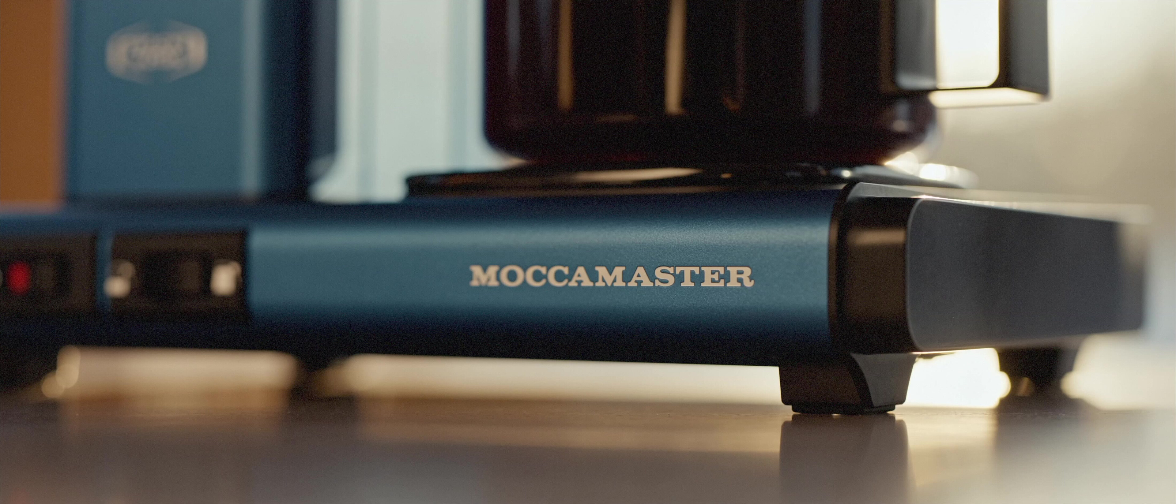 Moccamaster ICE - Moccamaster base with switches and wordmark in warm window light